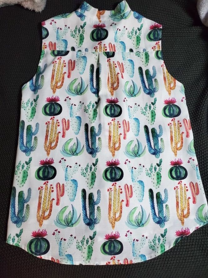 A shirt with a cactus print laid flat in preparation for a flat fold to show how to pack clothes for moving