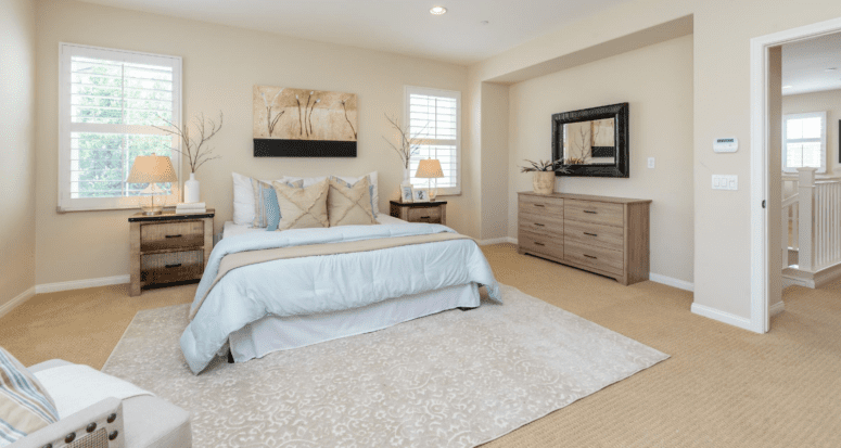 A cream, blue, and beige themed master bedroom.