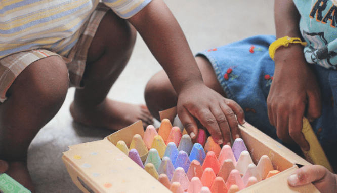 Kids playing with crayons while settling into a new house.