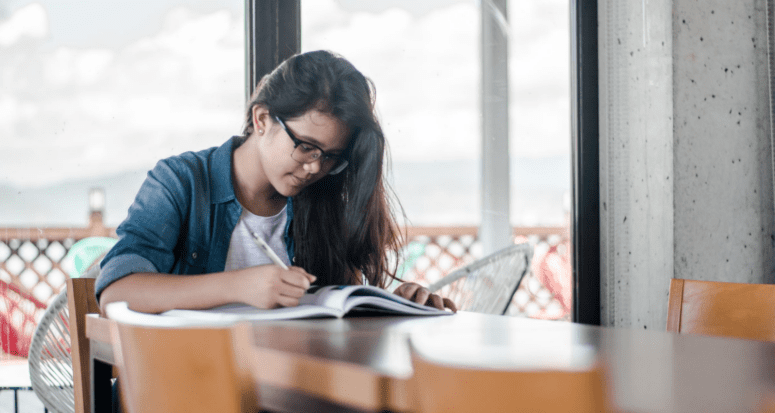 A woman writing notes about points on a mortgage loan.