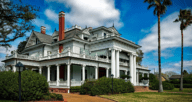 A Victorian-style house with a large wrap-around-porch, a house you could make an offer on.