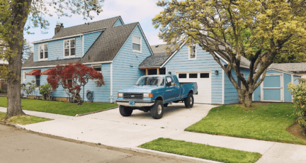 A paved driveway in front of a home with added value.