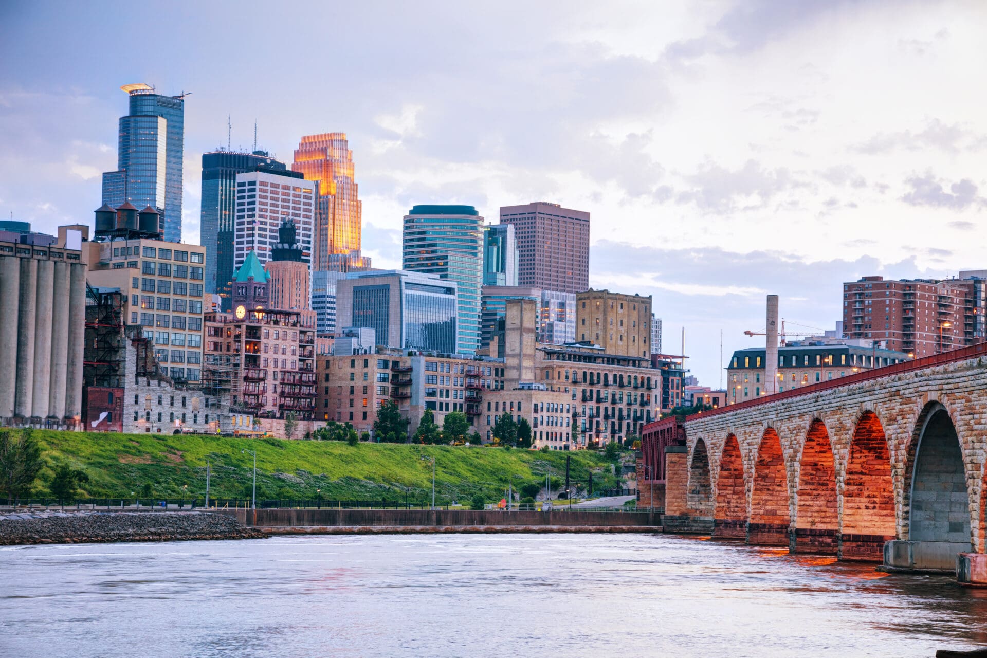 Downtown Minneapolis, Minnesota at night time as seen from the famous stone arch bridge