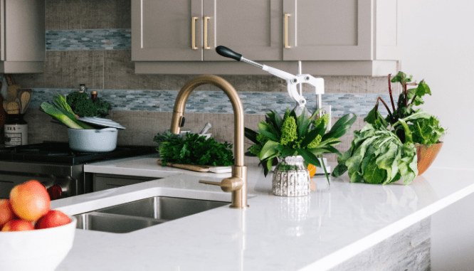 A kitchen with brass fixtures that are in style.