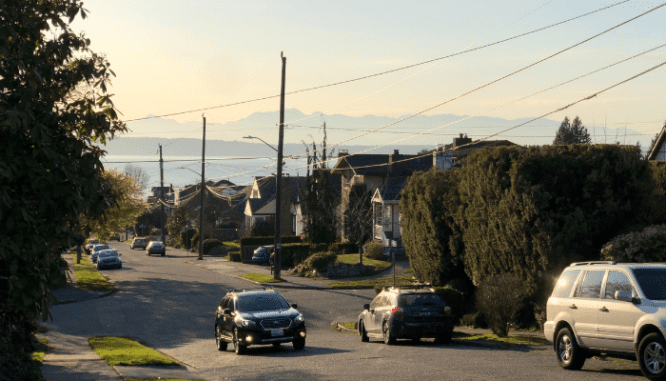 A car driving to buy a house in the suburbs.