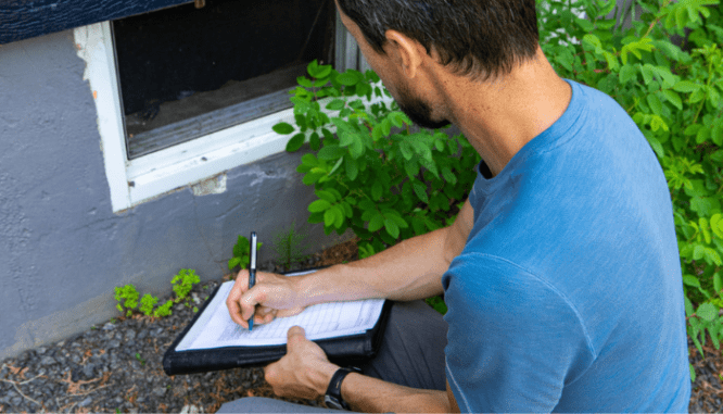 An inspector checking a home according to the owner's contract.