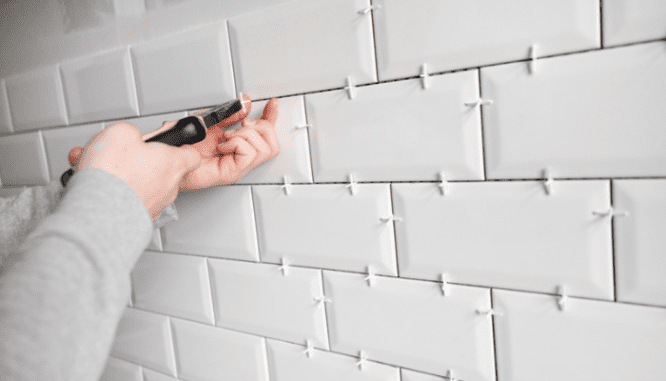 Subway tiles that are being installed in a bathroom.