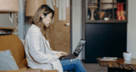 A woman using a computer to compare homeowners insurance.