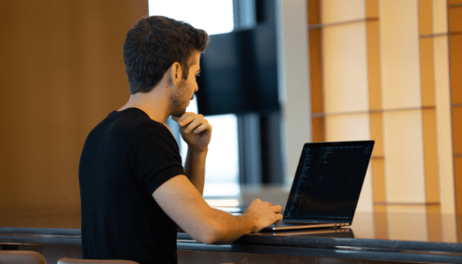 A person using a computer to sell a house in Riverside.