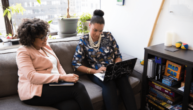 Two woman disclosing a house with old wiring before selling.