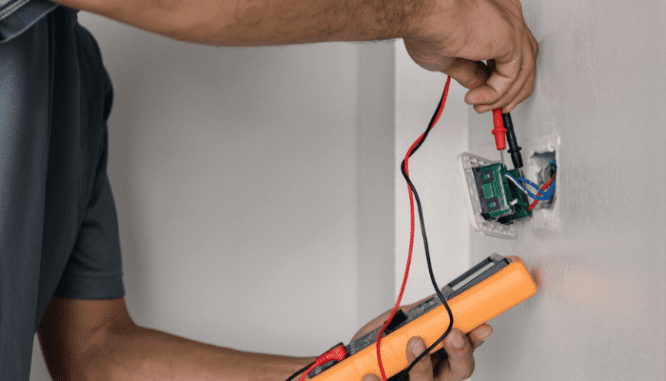 An inspector checking old wiring in a house.