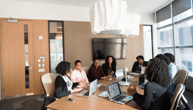 A group of sellers working with a real estate attorney in a conference room.