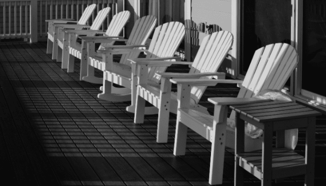 Chairs in front of a winter home with curb appeal.