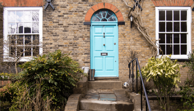 A blue door on a house with winter curb appeal.