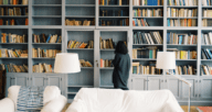 A woman perusing books on real estate investing.