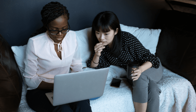 A real estate agent helping a buyer make an offer on a computer.