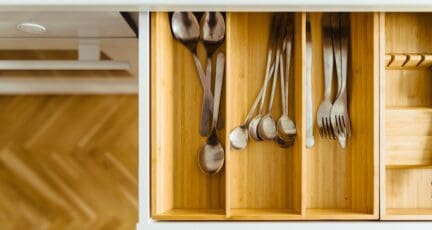 Utensils in a bamboo drawer organizer indicate the basics of what is a mortgage.