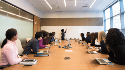 A real estate brokerage team in a meeting room.