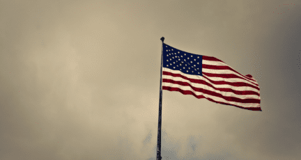 An American flag near a home sold by a military relocation professional.