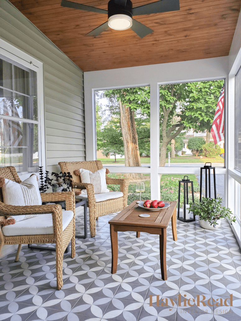 A porch with a ceiling fan that is not out of style.