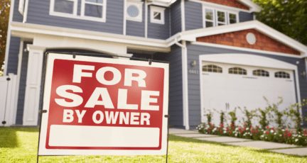 A fsbo sign in front of a house.