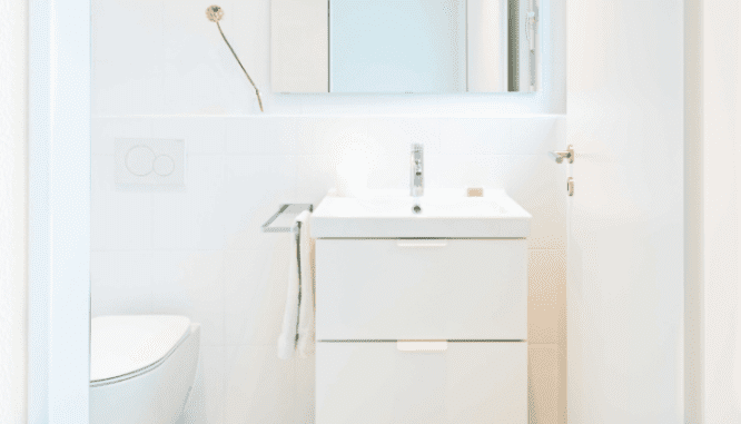 A bathroom that is white and out of style.