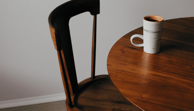 An image of a wooden table used to demonstrate the process of furnishing a new home.