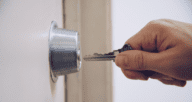 A key in a door to demonstrate a home buying timeline checklist.