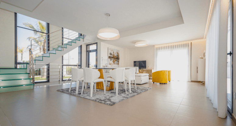 An open concept home with a dining table in the middle.