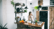 An image of a woman standing in a kitchenette.