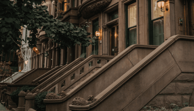 An image of a Brownstone on a street to depict what a Brownstone is.