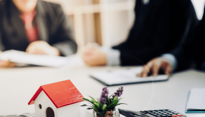 An image of a couple looking over a purchase agreement.