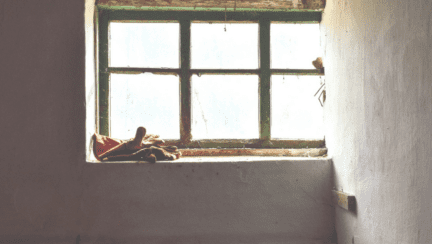 The windowsill of an old house, where you might deal with old house smells.