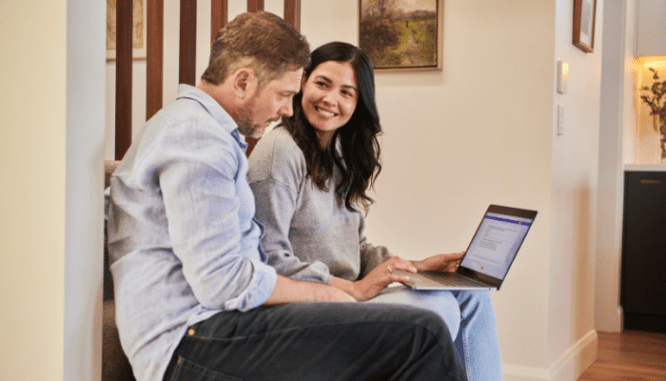 A couple looking at the costs to add a kitchenette to their house.