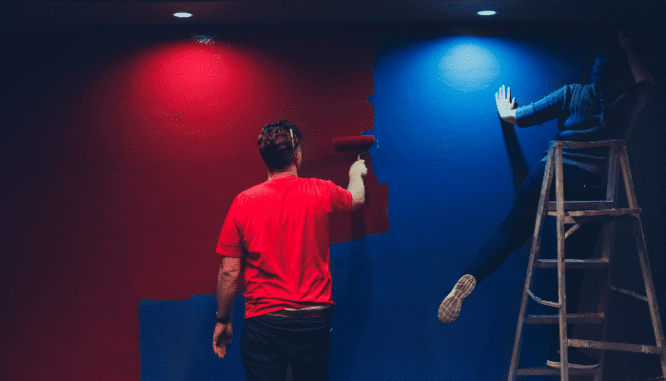 A person painting a wall in a property that's receiving an FHA loan.