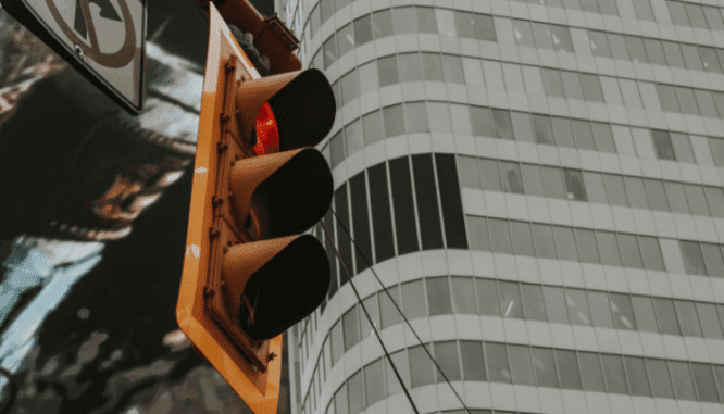 A traffic light near a house receiving an FHA loan.