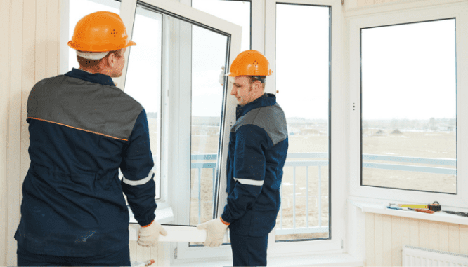 Two men installing sustainable windows into a home.