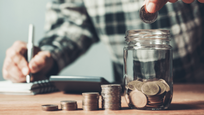 An image of a man saving money to demonstrate tips for saving for a house.