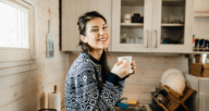 A woman drinking coffee to demonstrate what a microapartment is.