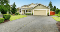 A house with a driveway that can be either asphalt or concrete.