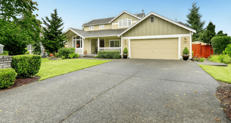 A house with a driveway that can be either asphalt or concrete.