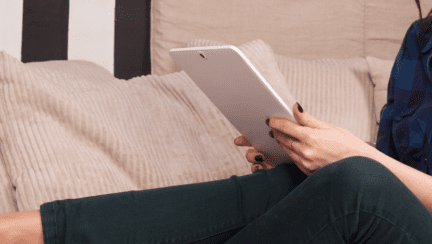 A woman using an iPad to research adjustable rate loans.