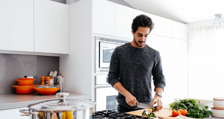 An image of a man in a kitchen to demonstrate if you should borrow money to renovate your home.