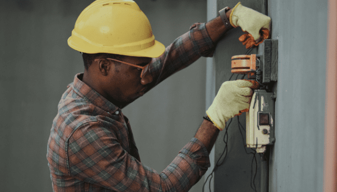 An image of a man repairing a house to demonstrate the process of flipping homes.