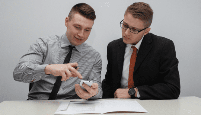 Two men discussing how much to set aside for a downpayment on a house.