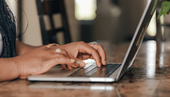 An image of hands typing to demonstrate how to get a mortgage loan.