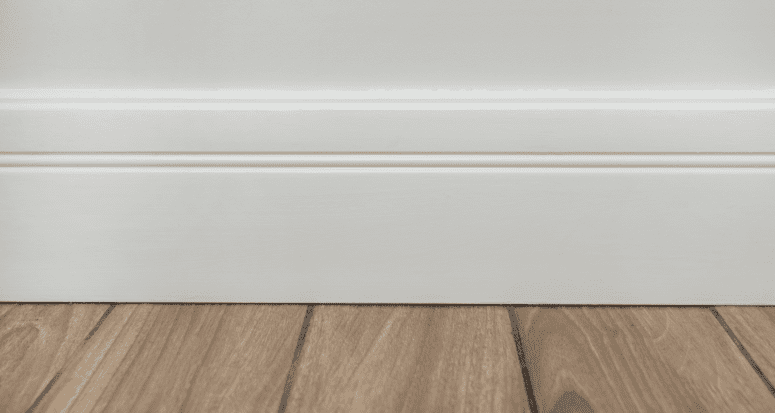 A wall with trim that has been painted white.