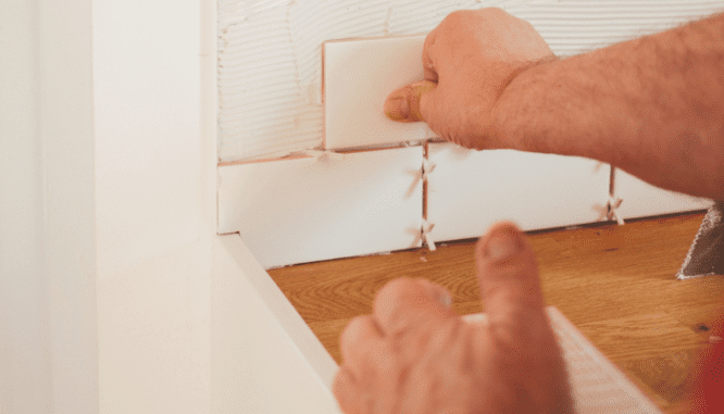 Tile is installed in the kitchen, one of the steps to building a house.