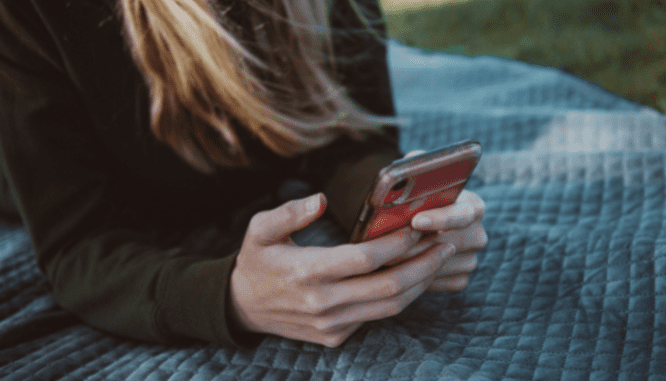 A person using a phone to get a reverse mortgage.