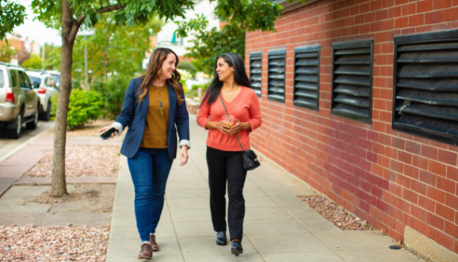 Two people talking about the differences between a real estate broker vs. an agent.